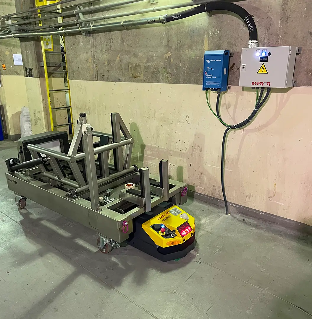 Empty AGV platform connected to wall-mounted charging unit at Cofrentes Nuclear Power Plant
