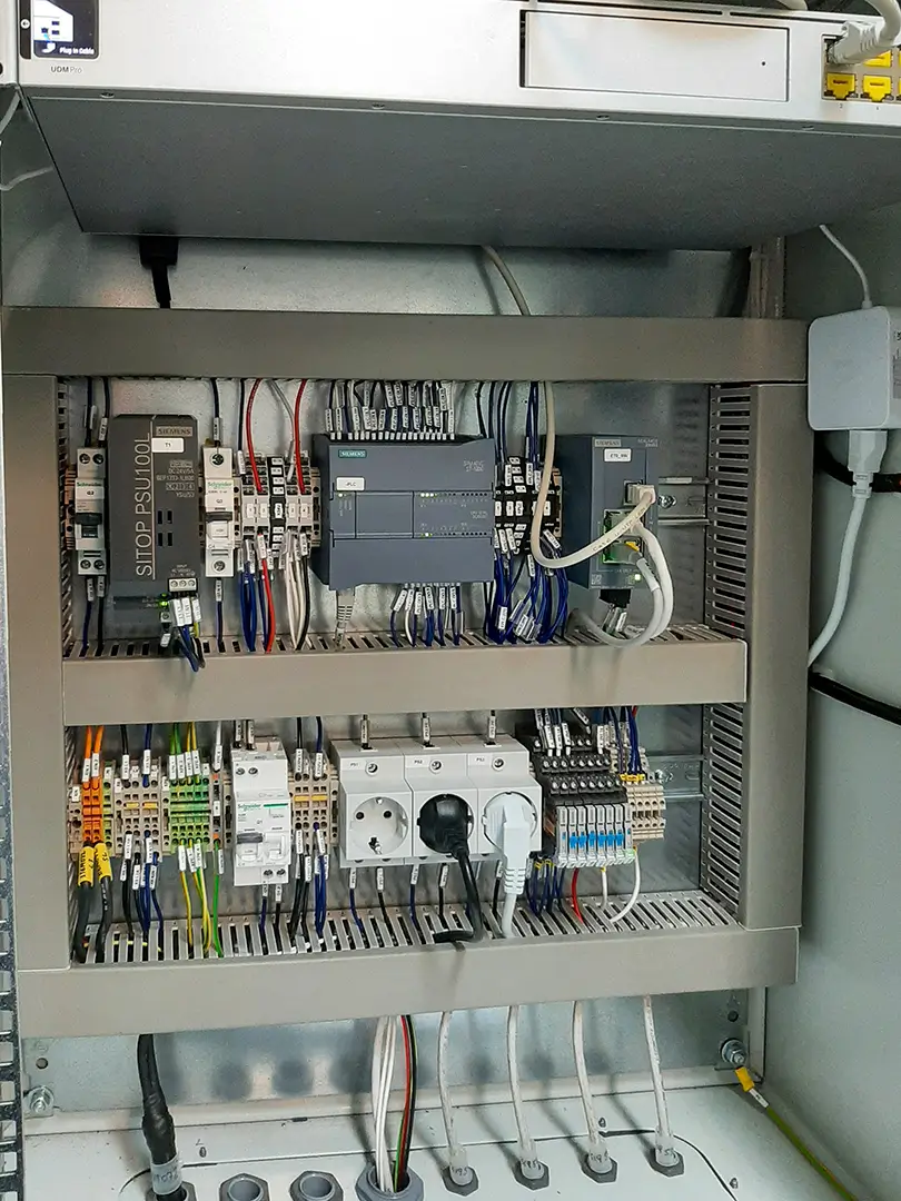 Siemens-based electrical panel showing the PLC, power supply units, and wiring used in NUSIM’s AGV system
